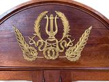 a wooden wall clock with a coat of arms on it