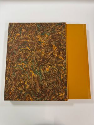 an open book with a yellow cover sitting on top of a white table