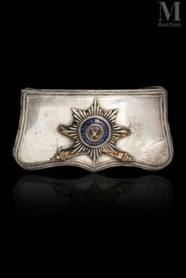 a close up of a belt buckle with a badge on it