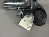 a gun with a note attached to it sitting on a table