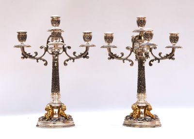 pair of antique silver plated candelabs with lions on them