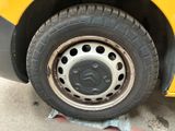 a close up of the tire of a yellow bus