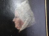 painting of a woman in a white bonnet and a black dress