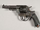 an old gun with a wooden handle on a white surface