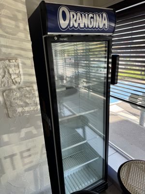 a glass door with a sign on it that says orangina