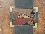an old book with a picture of a house on the cover