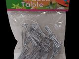 a bag of silver metal nails on a black background