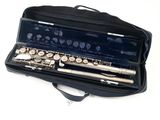 a flute in a black case on a white surface