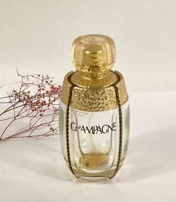 a bottle of champagne sitting on a table next to a flower