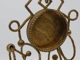 a metal object with a coin in the middle of it