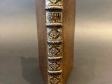 a book that is sitting on top of a wooden stand