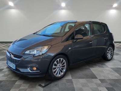 a grey car is parked in a room with a checkered floor