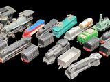 many different types of toy trains on a black background