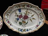two plates that have flowers on them on a table