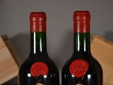 two bottles of wine sitting next to each other on a table