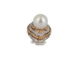 a close up of a pearl and diamond ring on a white background
