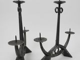 pair of black iron candlesticks with candles in the shape of a giraffe