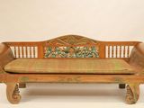 a wooden bench with a cushion on top of it