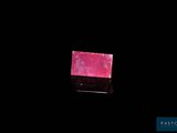 the pink soap bar is sitting on a black surface