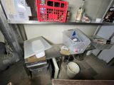 a small kitchen with a lot of clutter on the counter