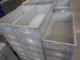many plastic containers stacked on top of each other in a warehouse