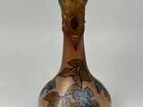 a vase with a floral design on it on a white surface