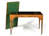 a small table with a piano on it and a green cover