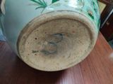 a vase sitting on a table with a wooden table top