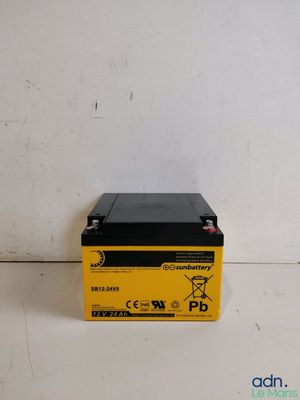 a yellow and black battery sits on a white surface