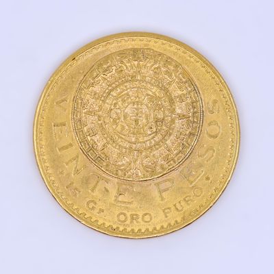 a gold coin on a white surface with a white background