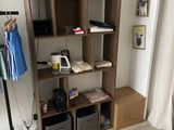 a room that has a shelf with clothes on it