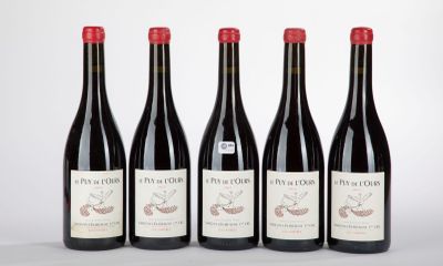 four bottles of wine are lined up in a row