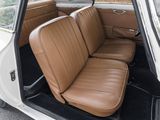 a white car with brown leather seats in the back of it
