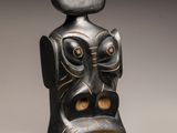 an image of a black and gold sculpture of a man ' s face