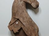 a wooden horse that is sitting on the floor