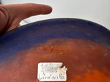 a hand that is holding a piece of paper in front of a bowling ball