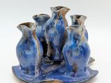 three vases that are sitting on a tray
