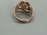 a close up of a gold ring with a diamond on it