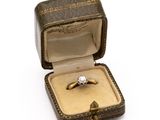 a ring in a box on a white surface