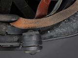 a close up of a motorcycle helmet with a leather strap
