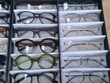 many pairs of glasses sitting in a drawer