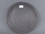 an image of a silver plate on a gray surface