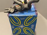 an elephant that is laying on top of a box