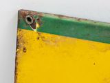 a yellow and green piece of metal with a bullet sticking out of it