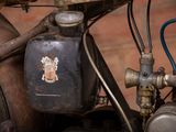 a close up of a motorcycle with a gas can attached to it