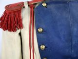an old blue and white uniform with a red tassel on the collar