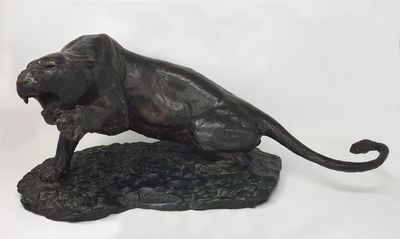 statue of a lion on a rock on a white background