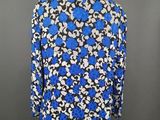 a blue and white floral blouse on a mannequin mannequin