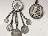 deux pièces d'argent et une pièce d'argent auxquelles sont suspendues des chaînes