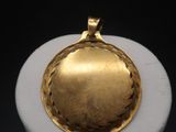 an image of a gold locke on a white pedestal